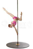 Redhead gymnast posing upside down on pylon