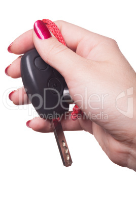 Close up of hand holding car key on white