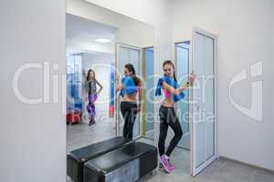 Sexy girls posing in locker room of fitness center
