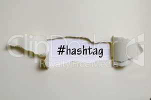 The word hashtag appearing behind torn paper