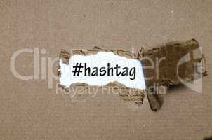 The word hashtag appearing behind torn paper