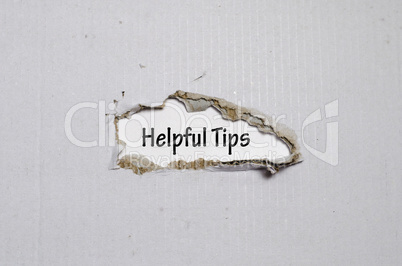 The word helpful tips appearing behind torn paper