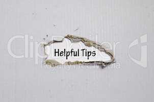 The word helpful tips appearing behind torn paper