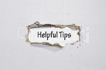 The word helpful tips appearing behind torn paper