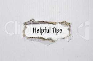 The word helpful tips appearing behind torn paper