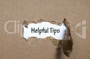 The word helpful tips appearing behind torn paper