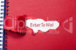 The word enter to win appearing behind torn paper