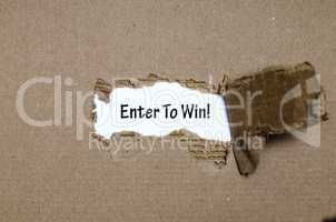 The word enter to win appearing behind torn paper