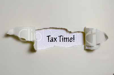 The word  tax time appearing behind torn paper