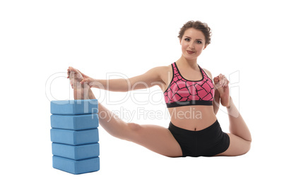 Sport. Image of woman stretching with bricks