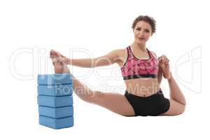 Sport. Image of woman stretching with bricks