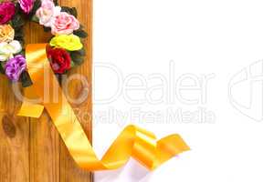 Traditional wreath with flowers and satin ribbon