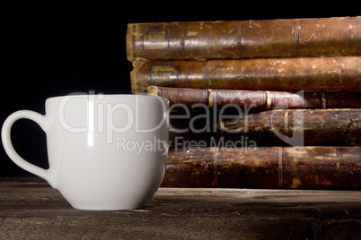 Old books and white cup