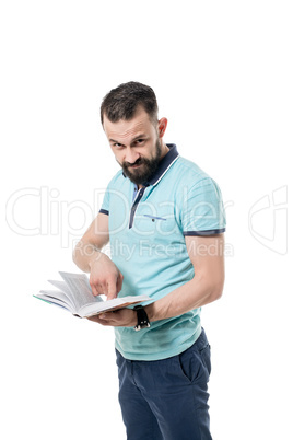 Bearded man looks at camera while shows the book