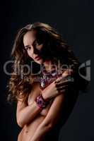 Chic. Beautiful naked woman posing in jewelry