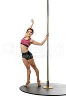 Dance. Graceful brunette posing with pole