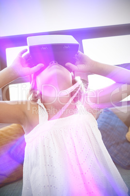 Elementary girl looking through virtual reality headset in schoo