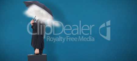 Composite image of businessman under umbrella while holding a br