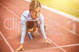 Composite image of businesswoman in the starting blocks