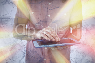 Composite image of mid section of hipster using digital tablet Composite image of mid section of hipster using digital tablet