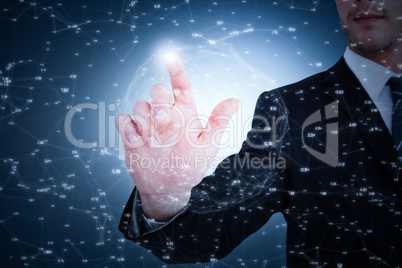 Composite image of focused businessman pointing with his finger