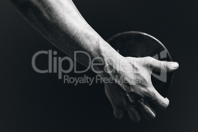 Composite image of close up of sportsman hand is holding a discu
