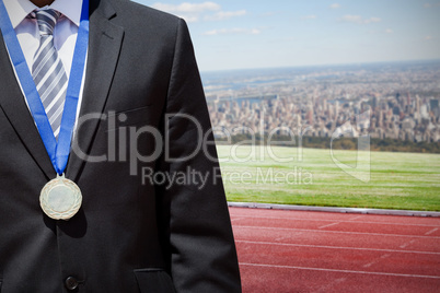 Composite image of close up of businessman chest with medal