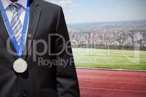 Composite image of close up of businessman chest with medal