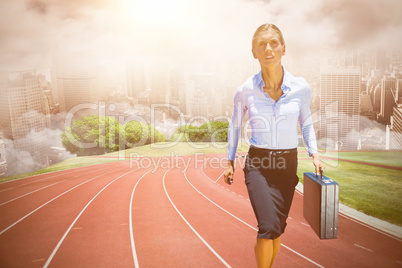 Composite image of businesswoman walking with briefcase