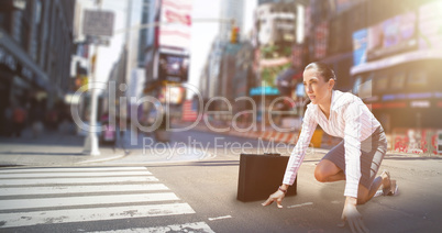 Composite image of businesswoman in starting blocks