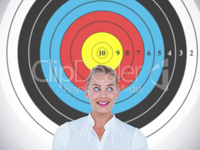 Composite image of smiling businesswoman looking up