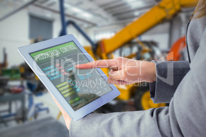 Composite image of businesswoman using a tablet pc