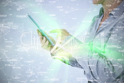 Composite image of businesswoman using her tablet