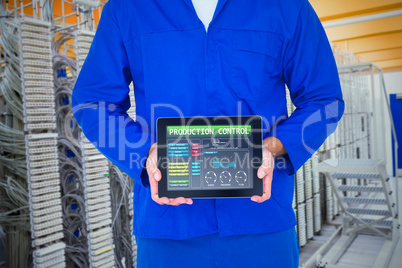 Composite image of smiling male mechanic showing digital tablet