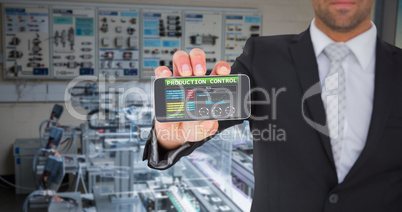 Composite image of businessman showing his smartphone screen