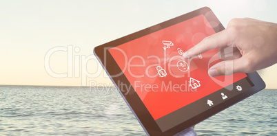 Composite image of man using tablet pc