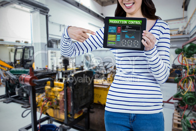 Composite image of mid section of woman pointing at tablet compu