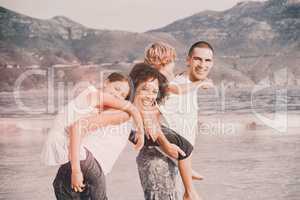 Happy family playing on the beach