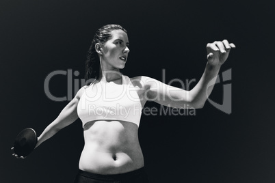 Composite image of front view of sportswoman practising discus t