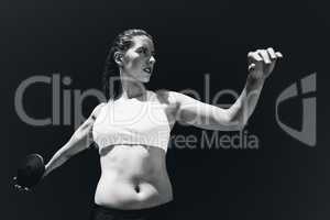 Composite image of front view of sportswoman practising discus t