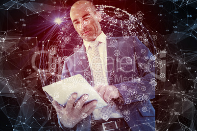 Composite image of businessman using a tablet