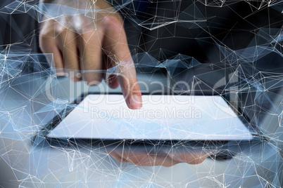 Composite image of businessman using digital tablet