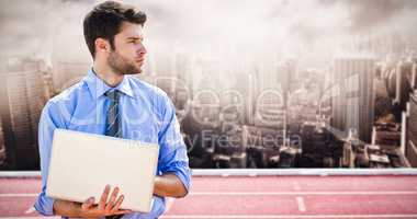 Composite image of businessman using a laptop