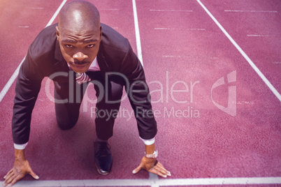 Composite image of close up of businessman in starting blocks