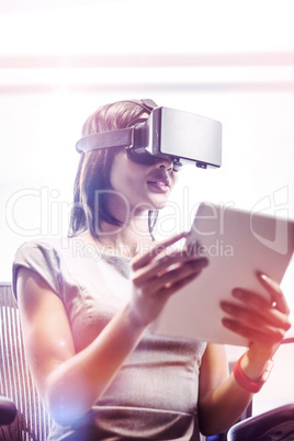 Businesswoman looking her tablet while using a virtual glasses