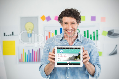 Composite image of businessman showing digital tablet with blank