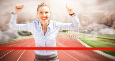 Composite image of successful businesswoman raising arms