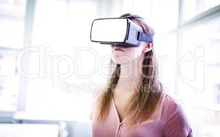 Graphic designer using virtual reality headset in office