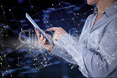 Composite image of businesswoman using her tablet