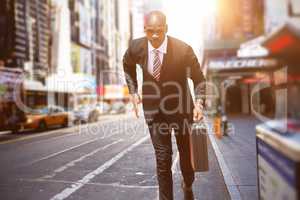 Composite image of businessman running